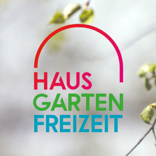 Das Haus Garten Freizeit Logo mit Ästen als Hintergrund