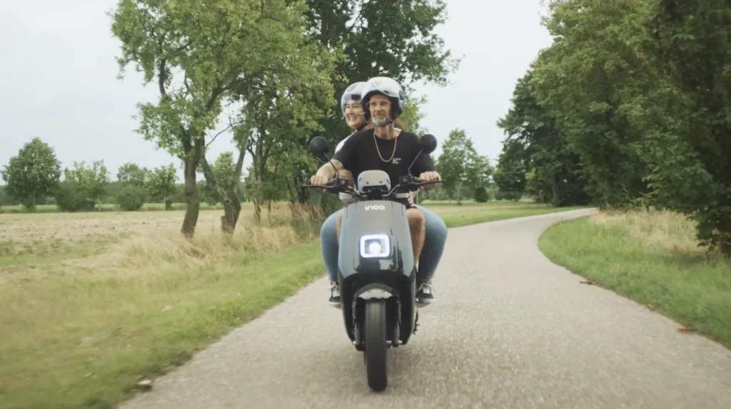 Bea und Daniel auf einem Roller am Fahren auf einer Landstraße